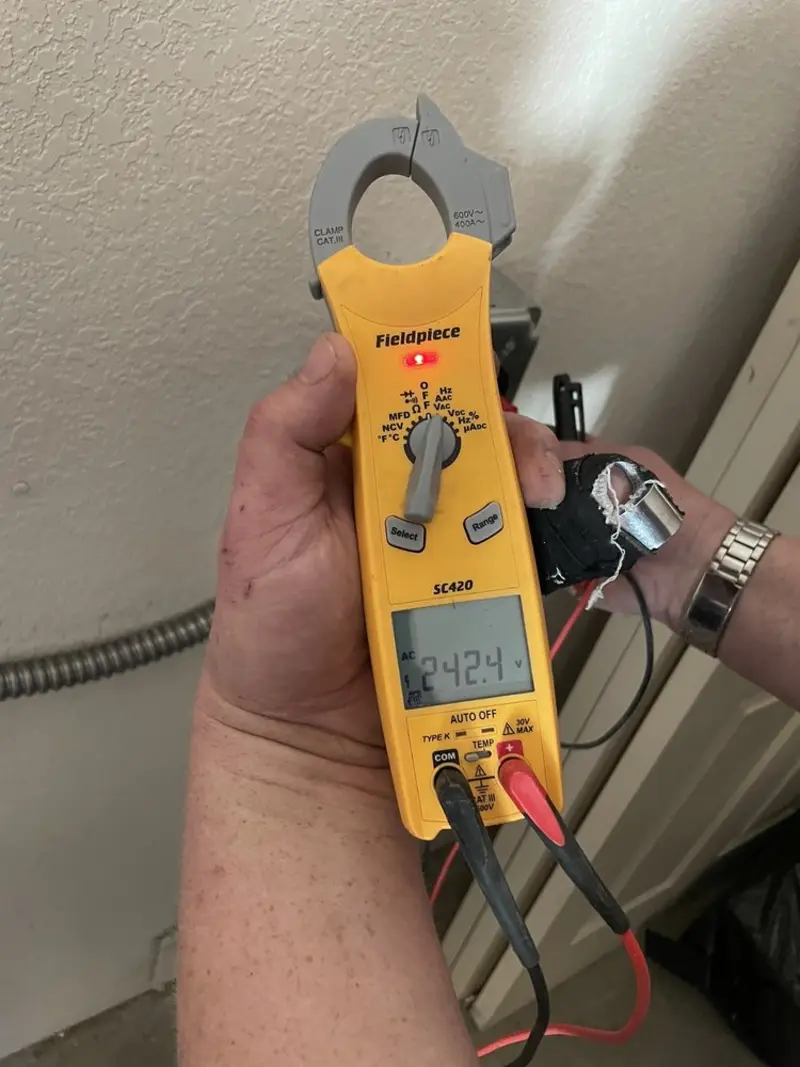 Voltage testing with clamp meter during Electrical Installation Services in Howe